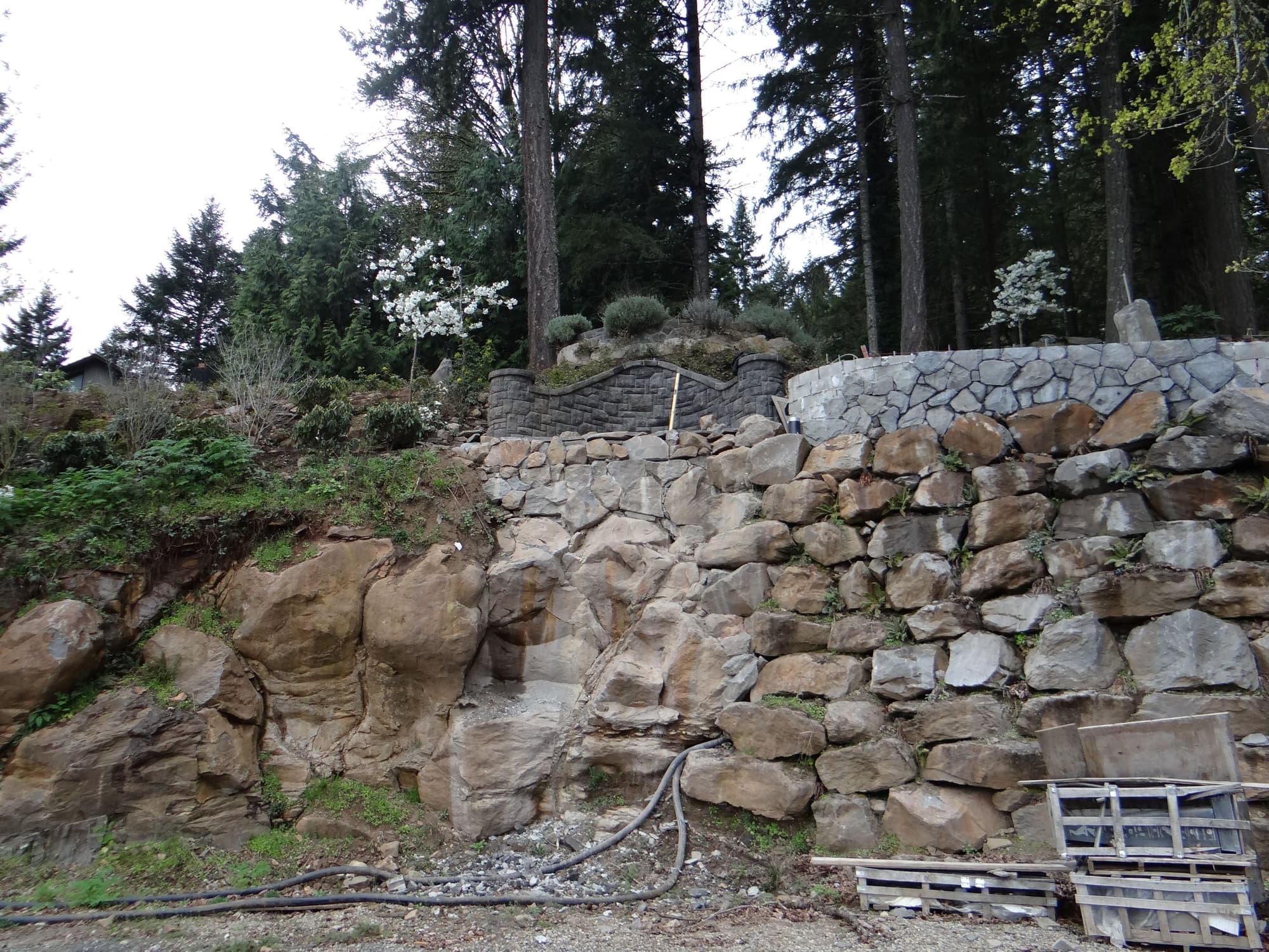 Boulder retaining wall hillside