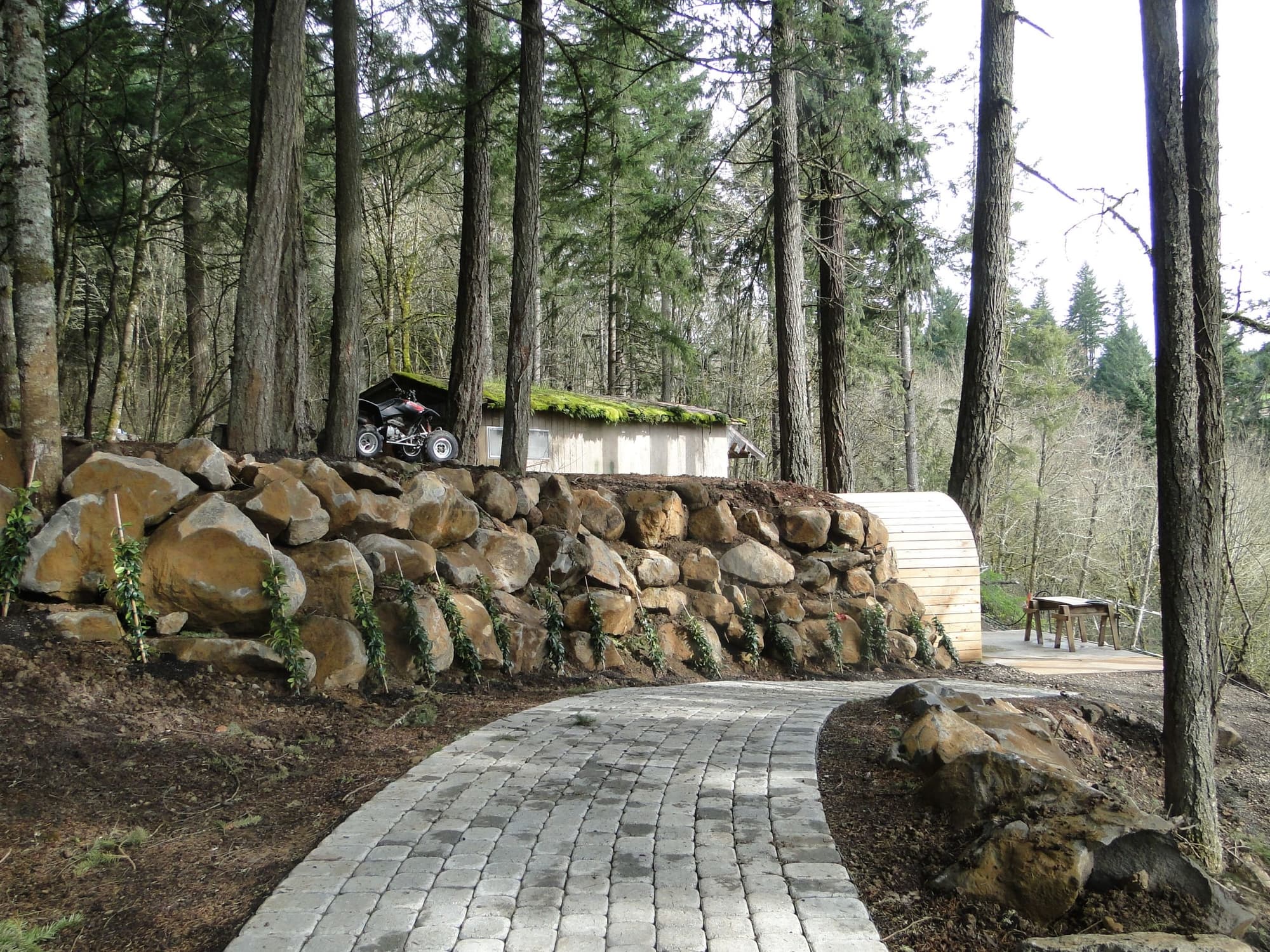 Boulder wall paver path