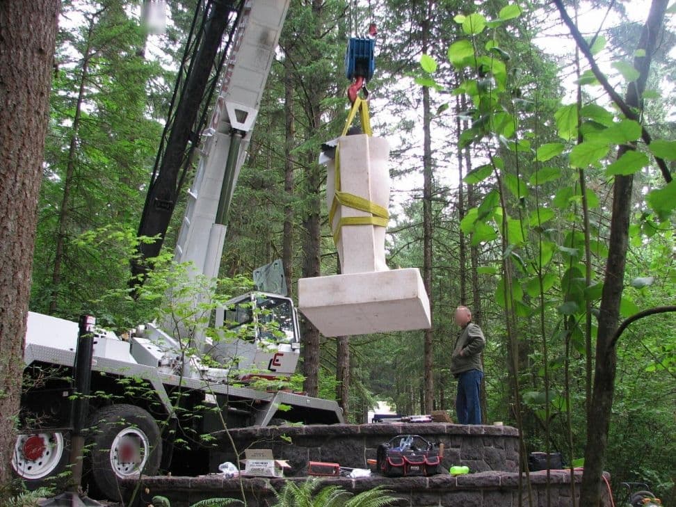 Crane hoisting statue base