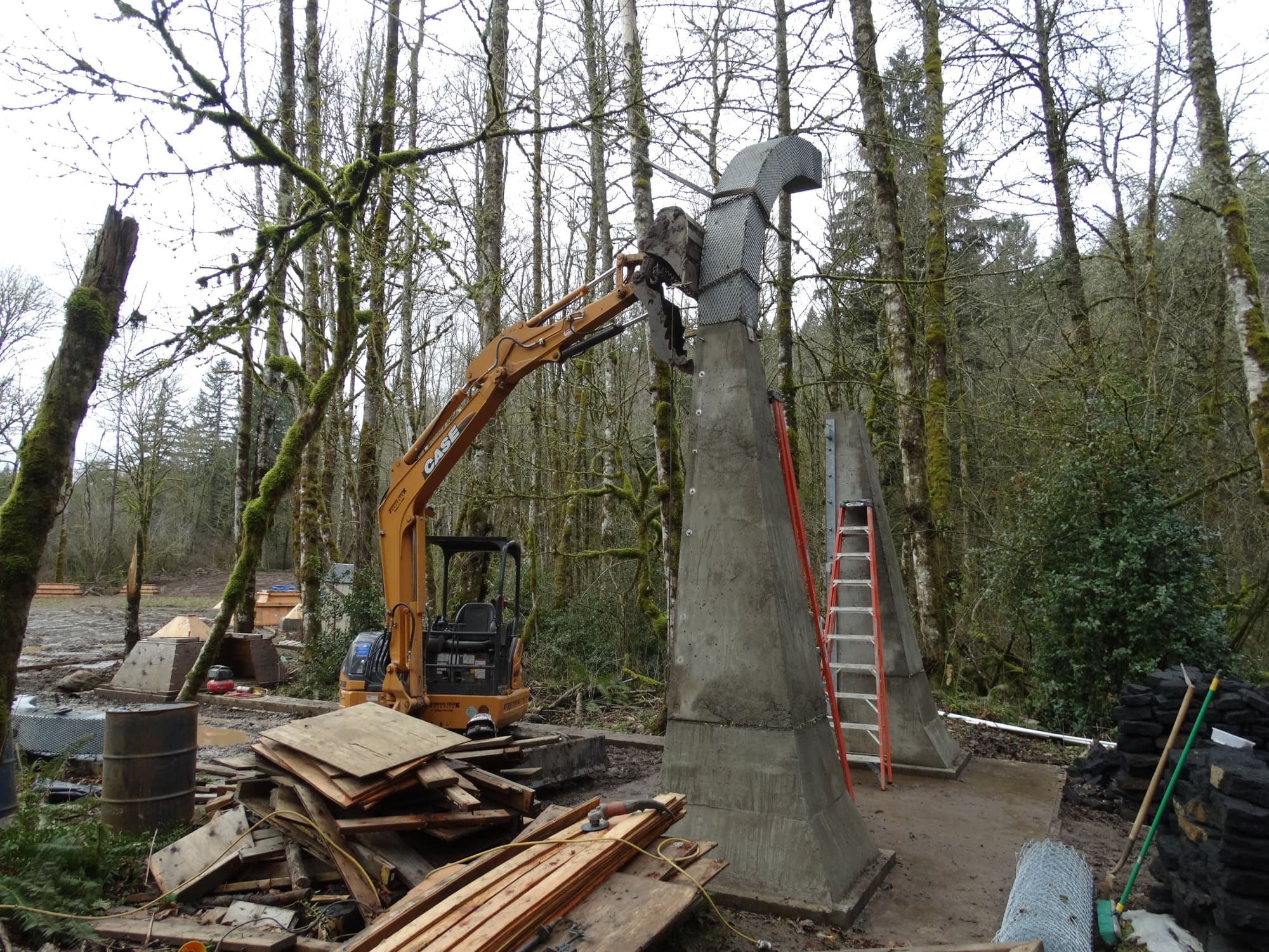 Excavator placing mesh arch