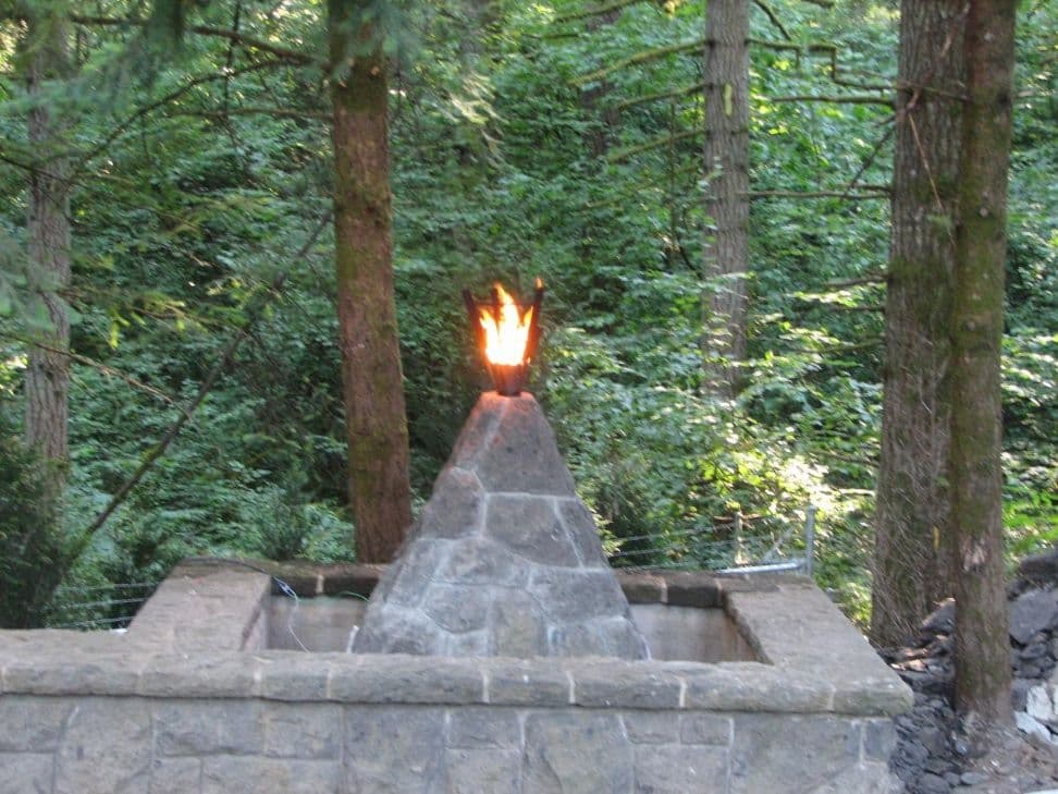 Flaming torch stone pyramid