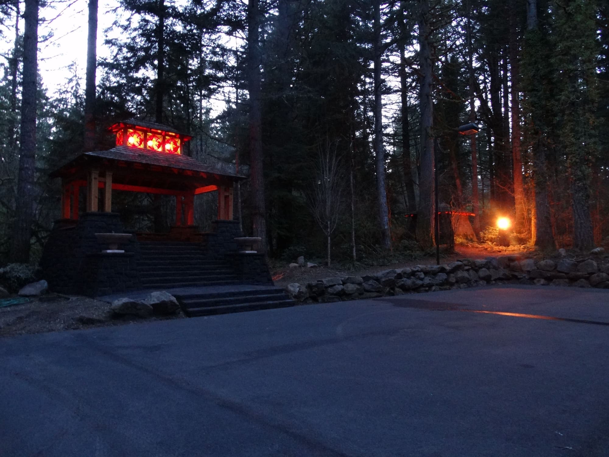 Red lit gazebo forest dusk