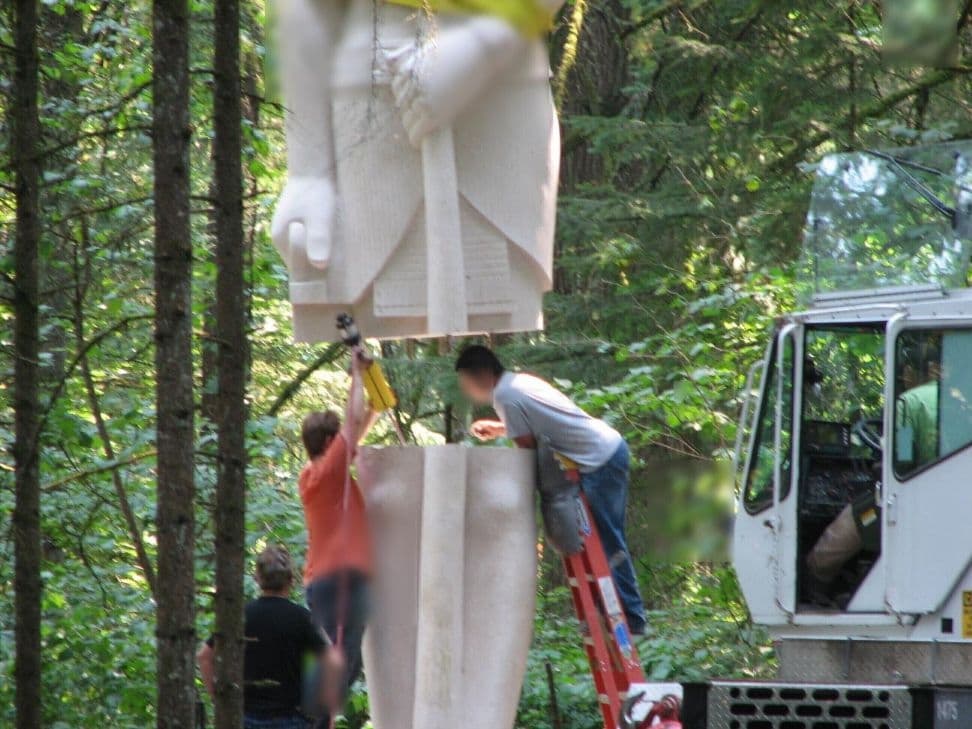Statue torso lowered workers