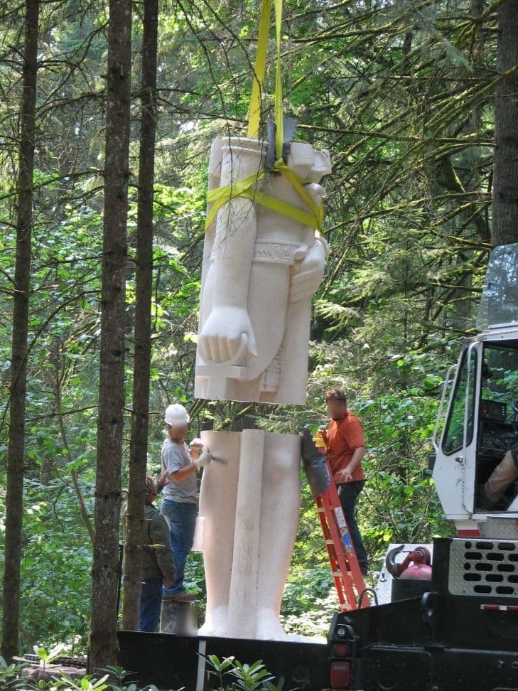 Statue torso lowering onto legs