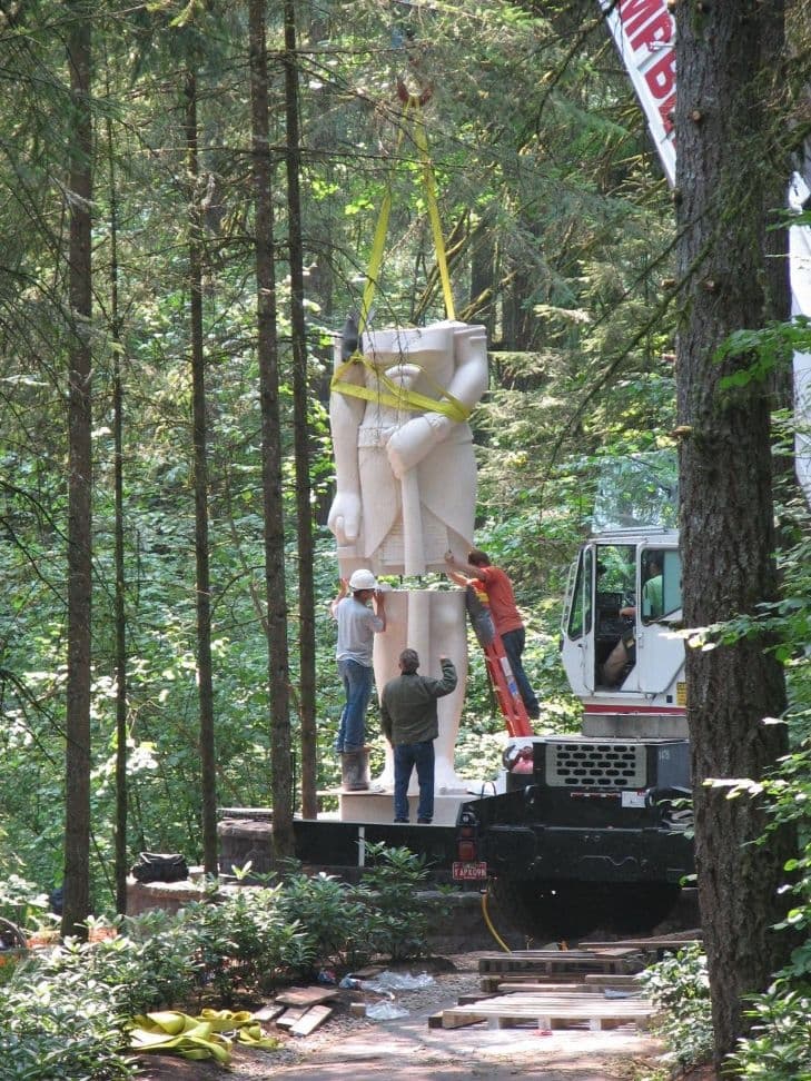 Workers assembling statue crane